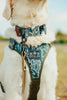Dog wearing a patterned camo harness and collar with 'K9 Tactical Gear' logo.